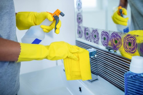 Team member using protective gloves and cleaning equipment